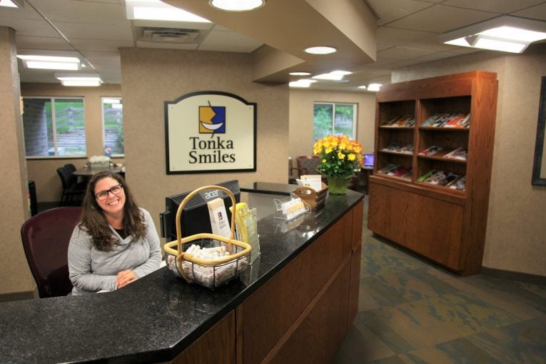 Office staff sitting on the front desk at Tonka Smiles [CITY] [STATE]