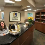Office staff sitting on the front desk at Tonka Smiles [CITY] [STATE]
