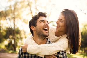 happy couple smiling and embracing each other outside