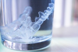 Invisalign aligners in glass of water