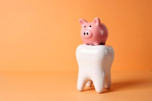 piggy bank on top of tooth